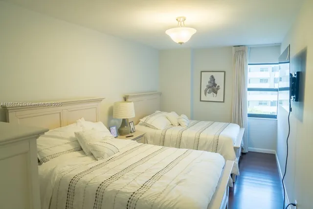 a bedroom with two beds and a chandelier