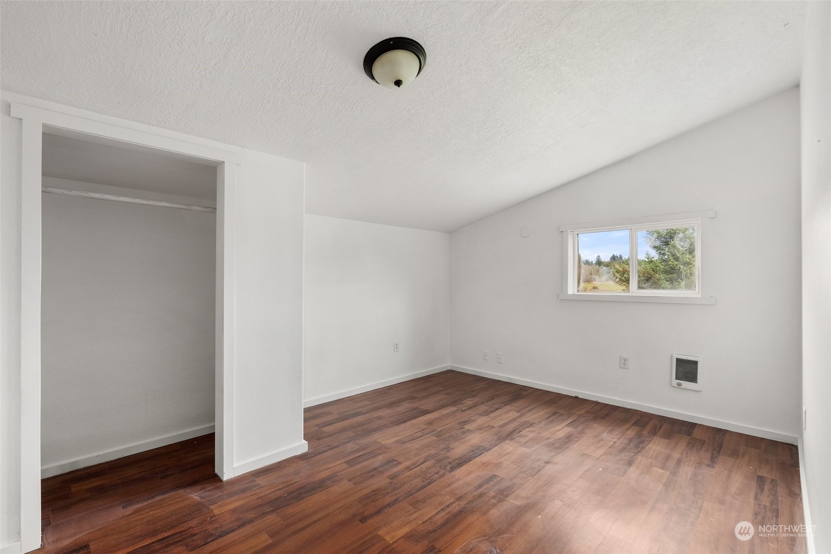 127 Remy Lane Chehalis, WA 98532 - Photo 17 of 24 an empty room with wooden floor and windows