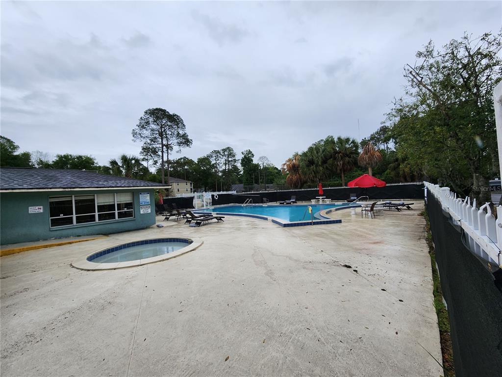 501 Southwest 75th Street, Unit A14 Gainesville, FL 32607 - Photo 49 of 56 swimming pool view with a seating space