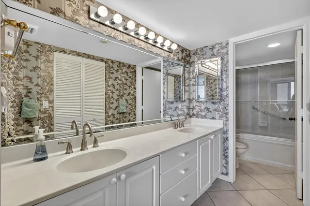 a swimming pool with outdoor seating and a palm tree