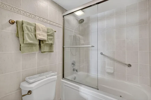 a view of swimming pool with outdoor seating and palm trees