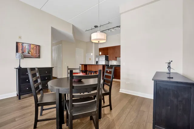 a dining room with furniture and wooden floor