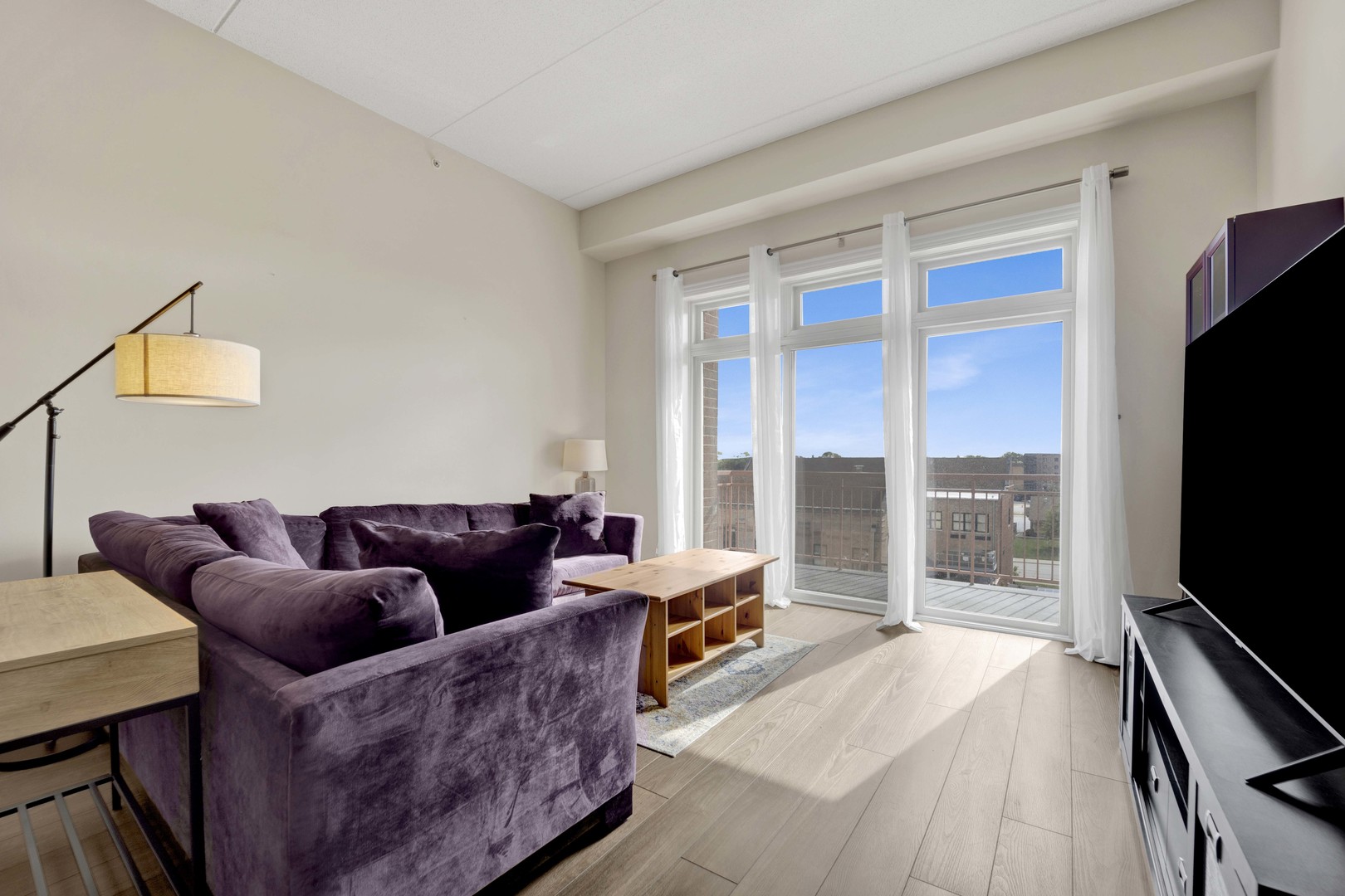 799 Graceland Avenue, Unit 504A Des Plaines, IL 60016 - Photo 12 of 25 a living room with furniture and a flat screen tv