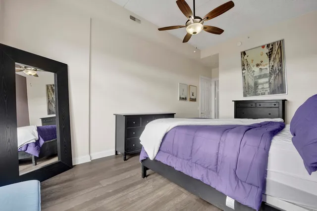 a bedroom with a bed and a chandelier