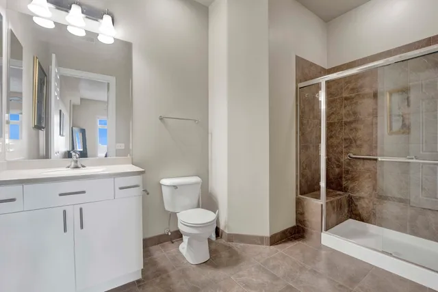 a bathroom with a toilet sink and shower