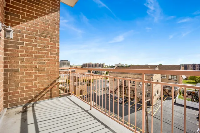 a view of a balcony with wooden floor and city view