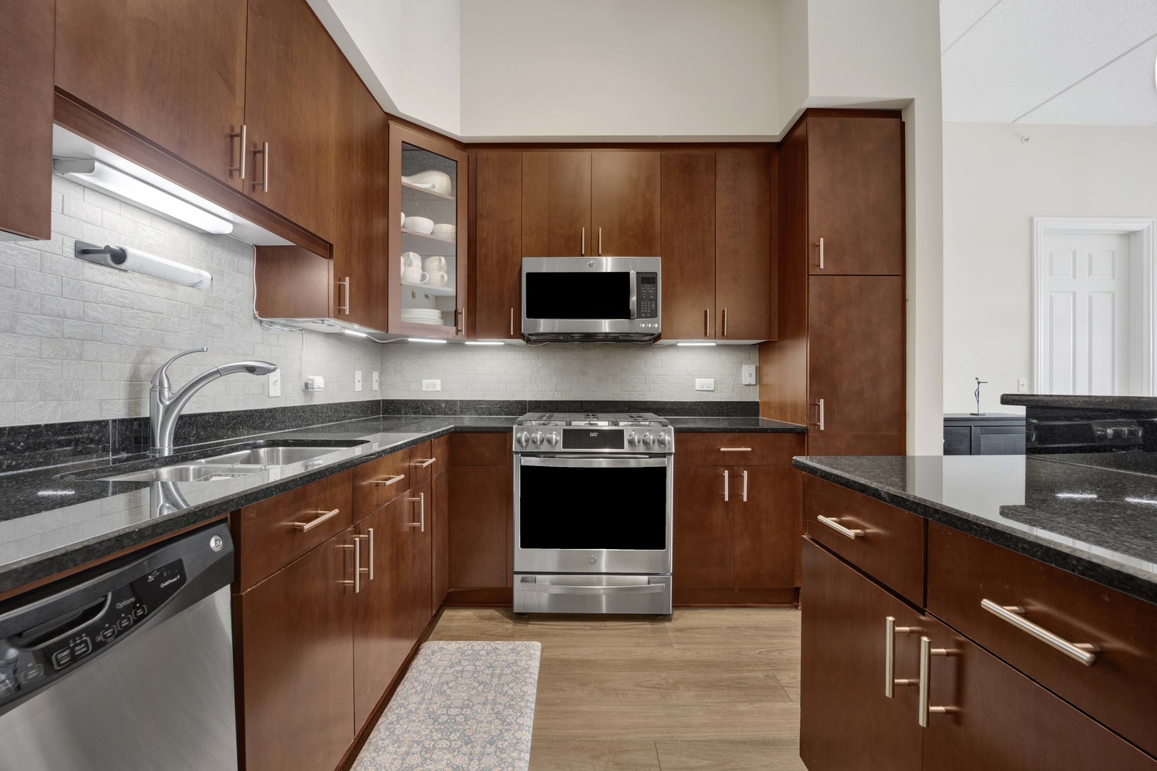 799 Graceland Avenue, Unit 504A Des Plaines, IL 60016 - Photo 5 of 25 a kitchen with stainless steel appliances granite countertop a stove a sink and a microwave