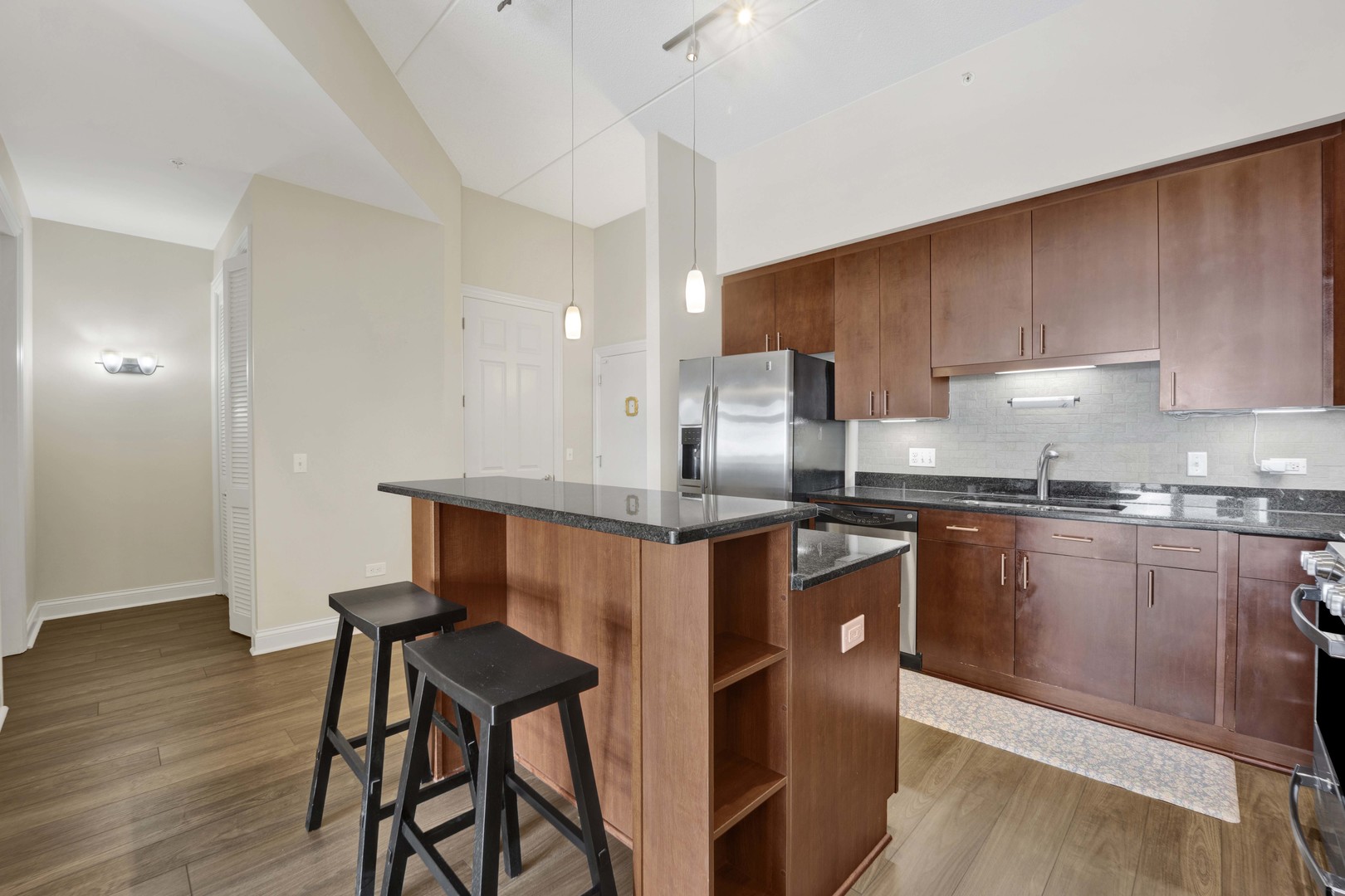 799 Graceland Avenue, Unit 504A Des Plaines, IL 60016 - Photo 8 of 25 a kitchen with stainless steel appliances a refrigerator a sink a stove a microwave and wooden cabinets