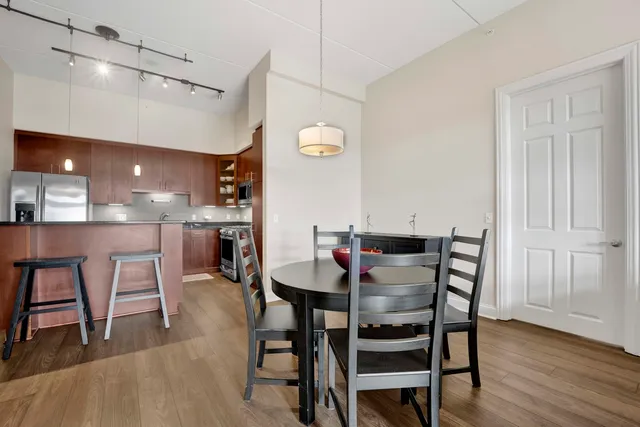 a view of a dining room with furniture and wooden floor
