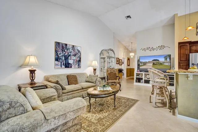 a dining room with stainless steel appliances kitchen island a table and chairs