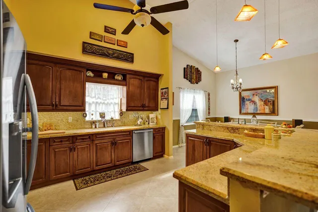 a kitchen with a sink a counter space and stainless steel appliances