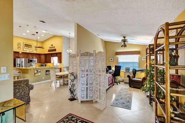 a living room with furniture and a potted plant