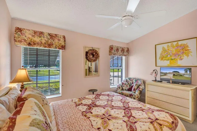 a view of a yard in front of a house with large tree