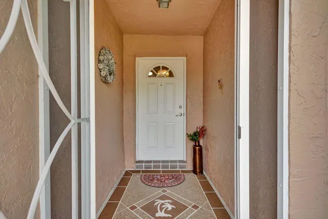 a living room with furniture and a dining table with wooden floor
