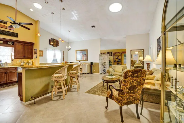 a living room with furniture a lamp and a flat screen tv