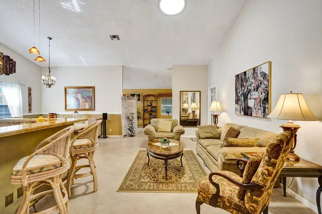a living room with furniture a rug and a chandelier