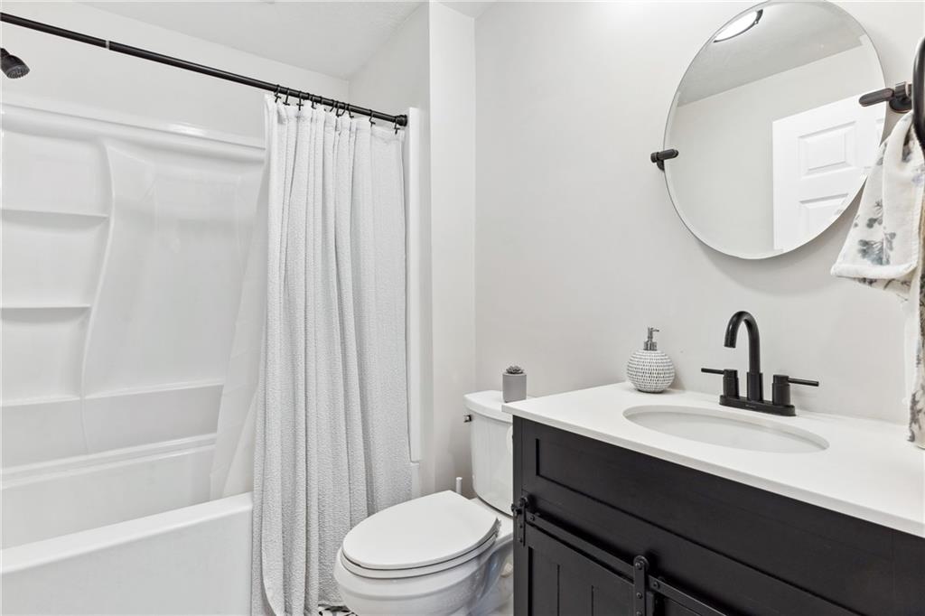 205 Rennick Road Butler, PA 16002 - Photo 10 of 40 a bathroom with a sink a toilet and a mirror