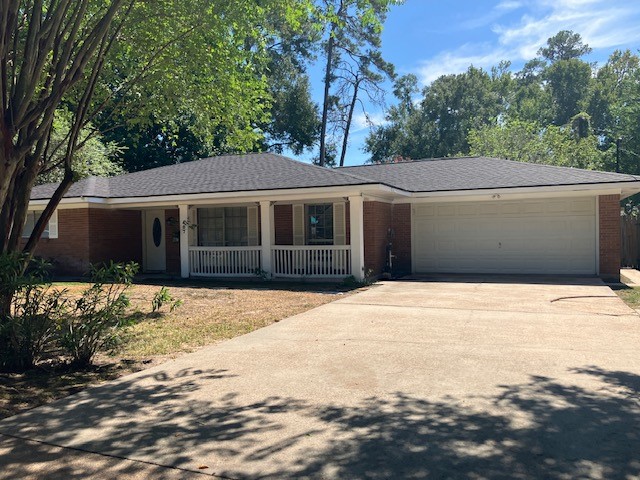 407 Wilson Road Conroe, TX 77301 - Photo 2 of 24 Home features cute front porch, double driveway and two car garage.