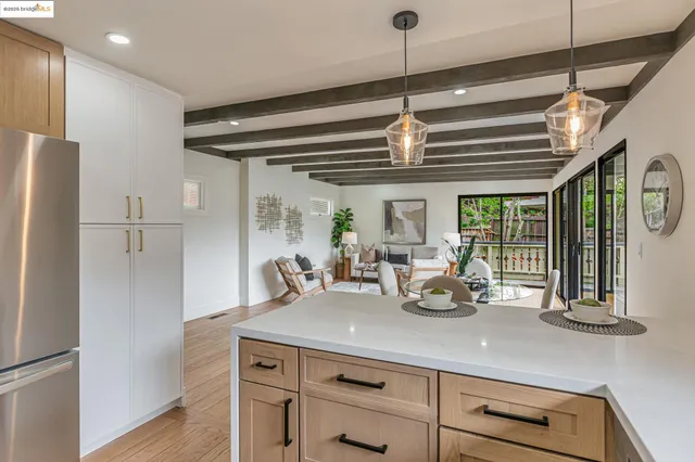 a kitchen with a counter space a sink and refrigerator