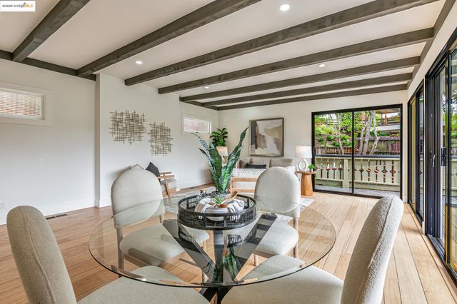 a view of a dining room with furniture wooden floor and a chandelier