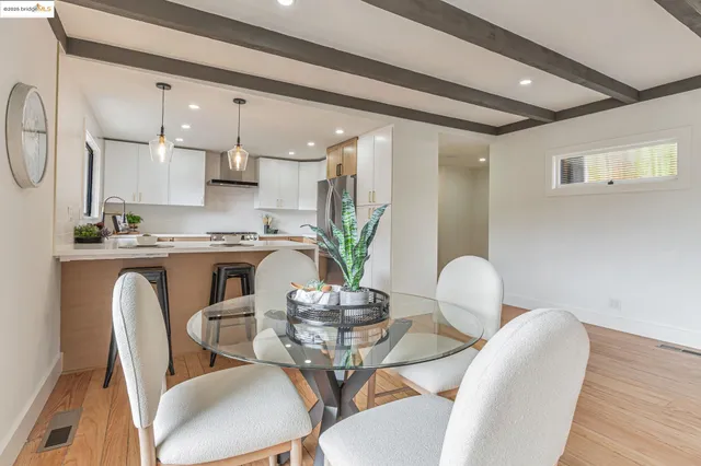 a dining room with furniture and wooden floor