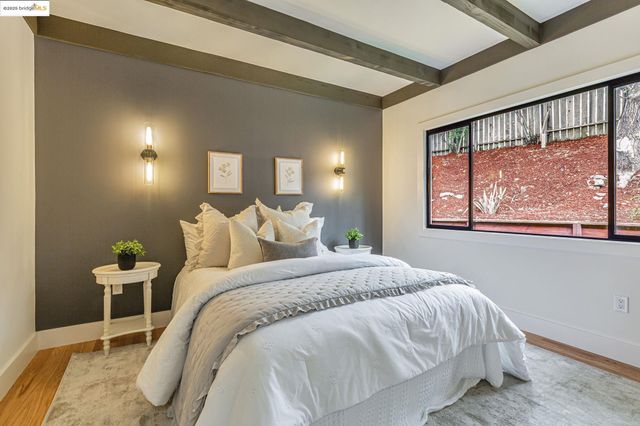 a bed sitting in a bedroom next to a window