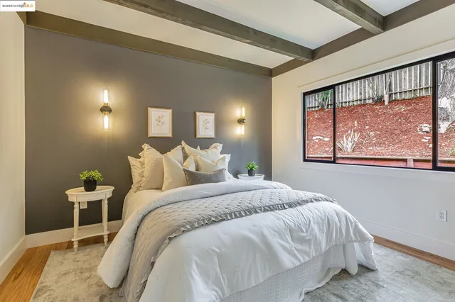 a bed sitting in a bedroom next to a window