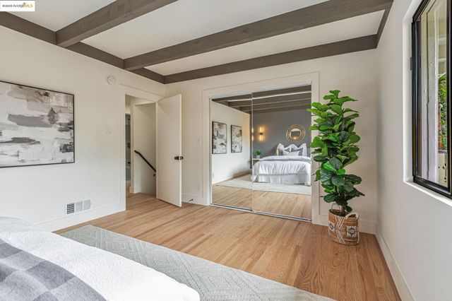 a bedroom with a large bed and a potted plant
