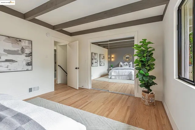 a bedroom with a large bed and a potted plant