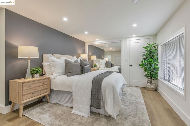 a bedroom with bed and a large mirror