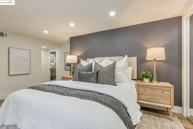 a bedroom with a bed and a lamp