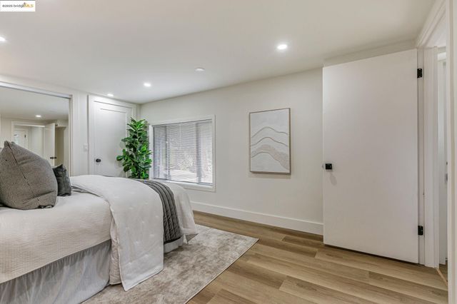 a bedroom with a large bed and a potted plant