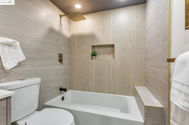 a bathroom with a toilet and a bathtub