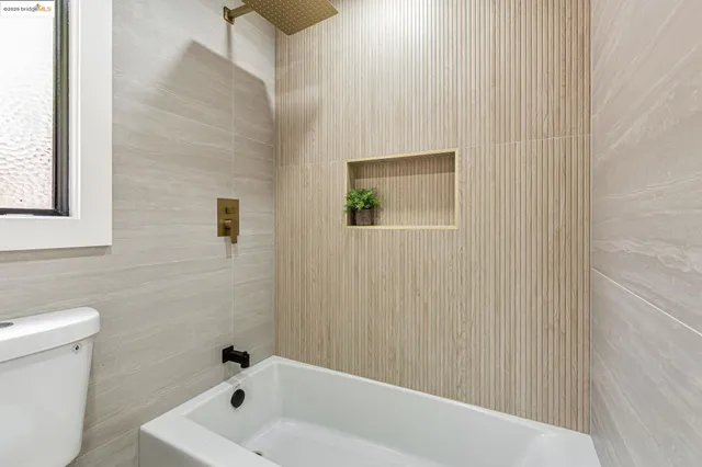 a bathroom with a bathtub and a toilet