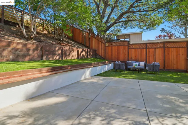 a view of a backyard with wooden fence