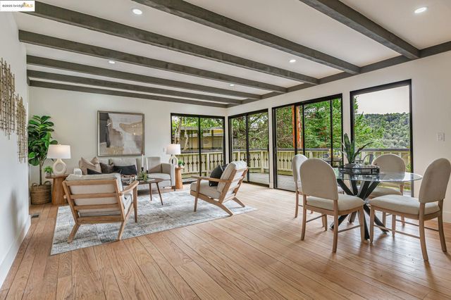 a dining room with wooden floor glass table and chairs