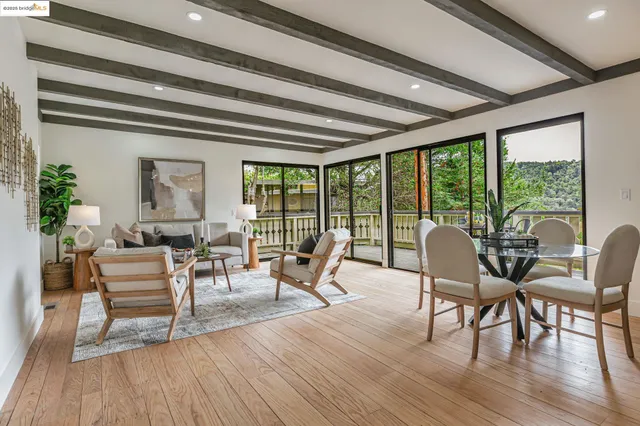 a dining room with wooden floor glass table and chairs