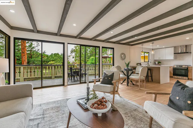 a living room with furniture and a floor to ceiling window