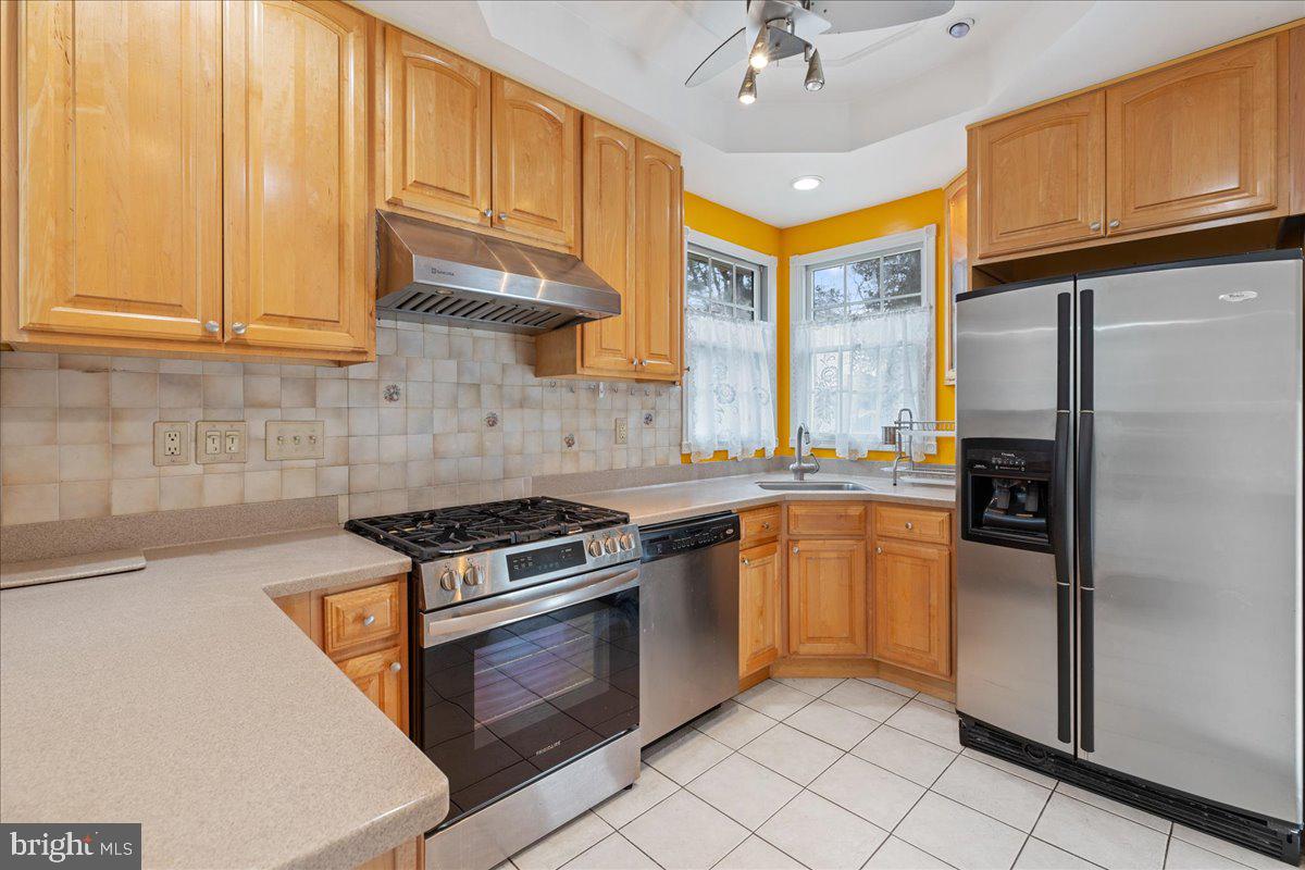 303 East Evesham Road Voorhees, NJ 08043 - Photo 11 of 34 a kitchen with stainless steel appliances granite countertop a stove a refrigerator and a sink dishwasher with wooden cabinets
