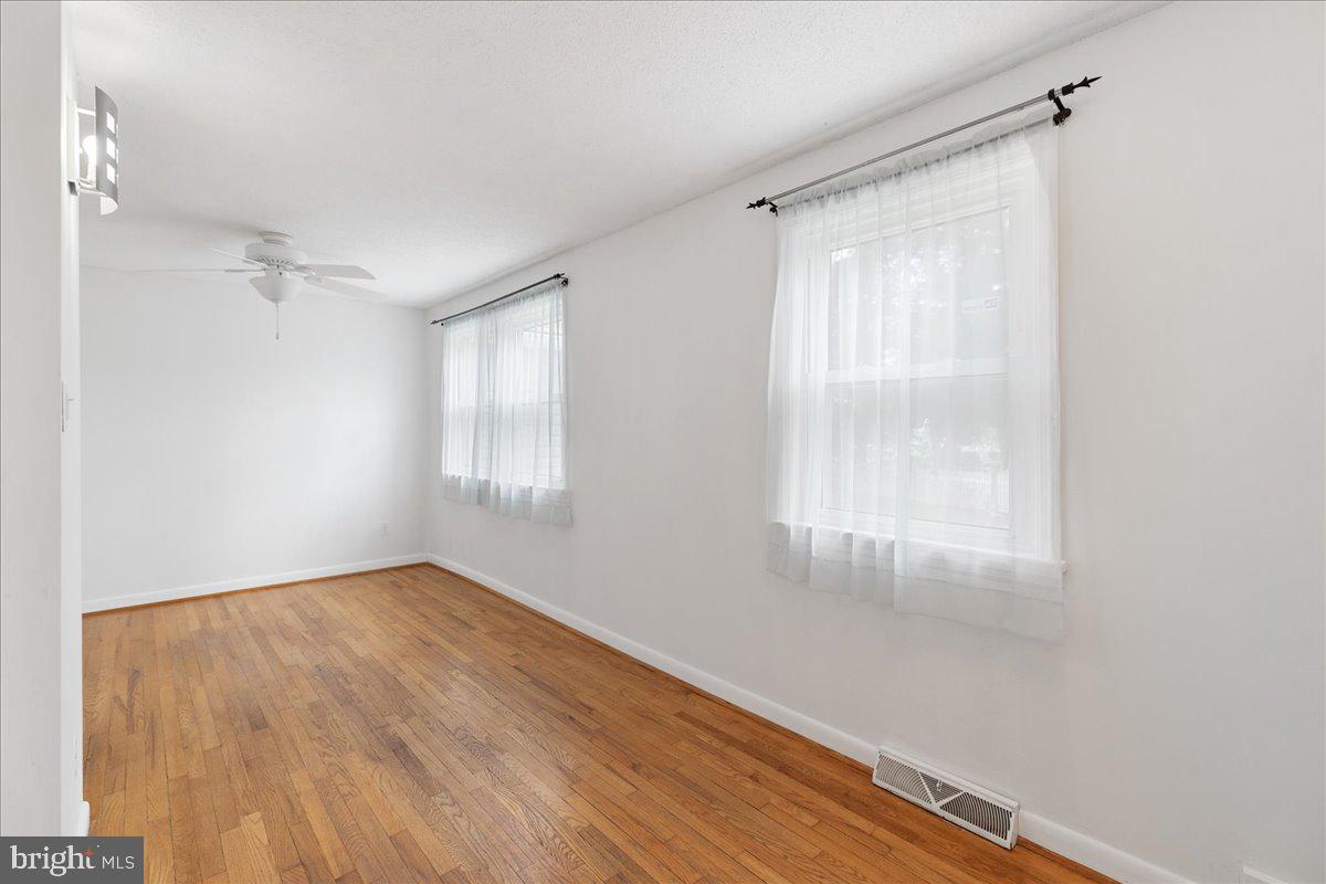 303 East Evesham Road Voorhees, NJ 08043 - Photo 21 of 34 a view of an empty room with wooden floor and a window