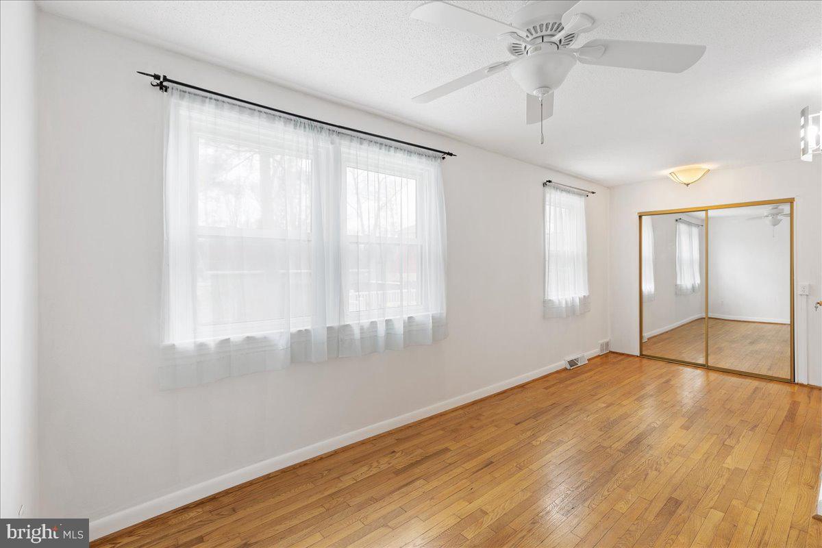 303 East Evesham Road Voorhees, NJ 08043 - Photo 22 of 34 a view of an empty room with wooden floor and a window