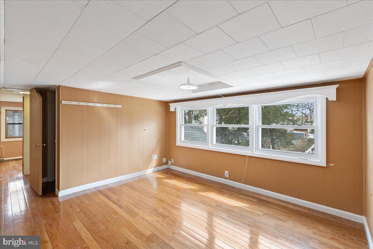 303 East Evesham Road Voorhees, NJ 08043 - Photo 24 of 34 an empty room with wooden floor and windows