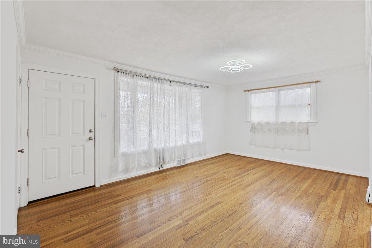 303 East Evesham Road Voorhees, NJ 08043 - Photo 6 of 34 a view of an empty room with wooden floor and a window