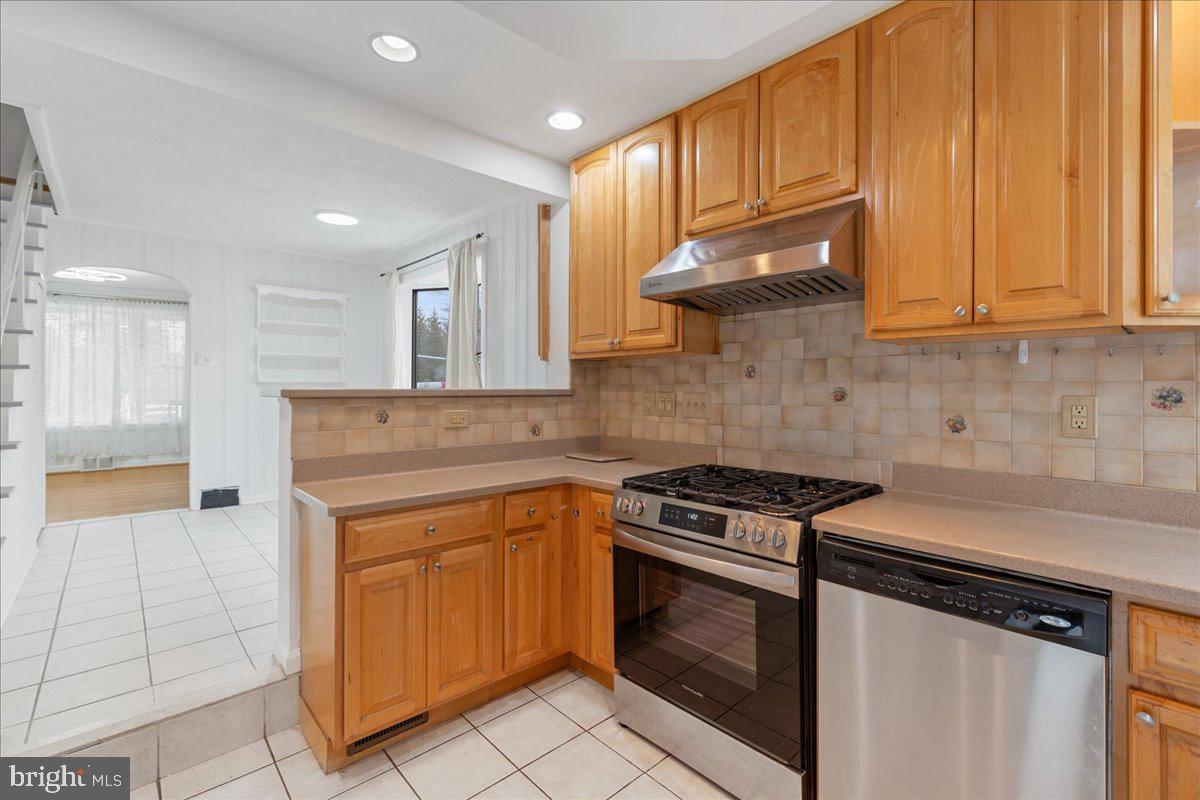 303 East Evesham Road Voorhees, NJ 08043 - Photo 10 of 34 a kitchen with stainless steel appliances granite countertop a stove a sink and a microwave