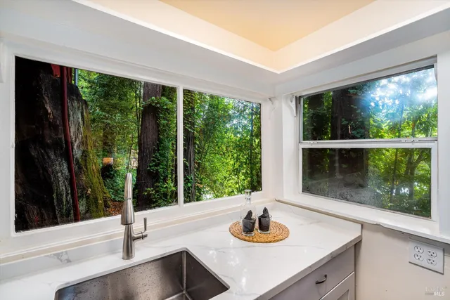 a kitchen with a sink and a large window