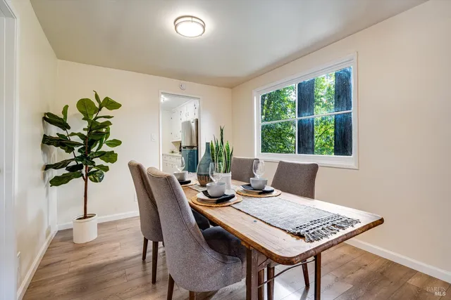 a view of a dining room with furniture window and wooden floor