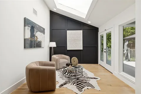 a bedroom with furniture and a large window