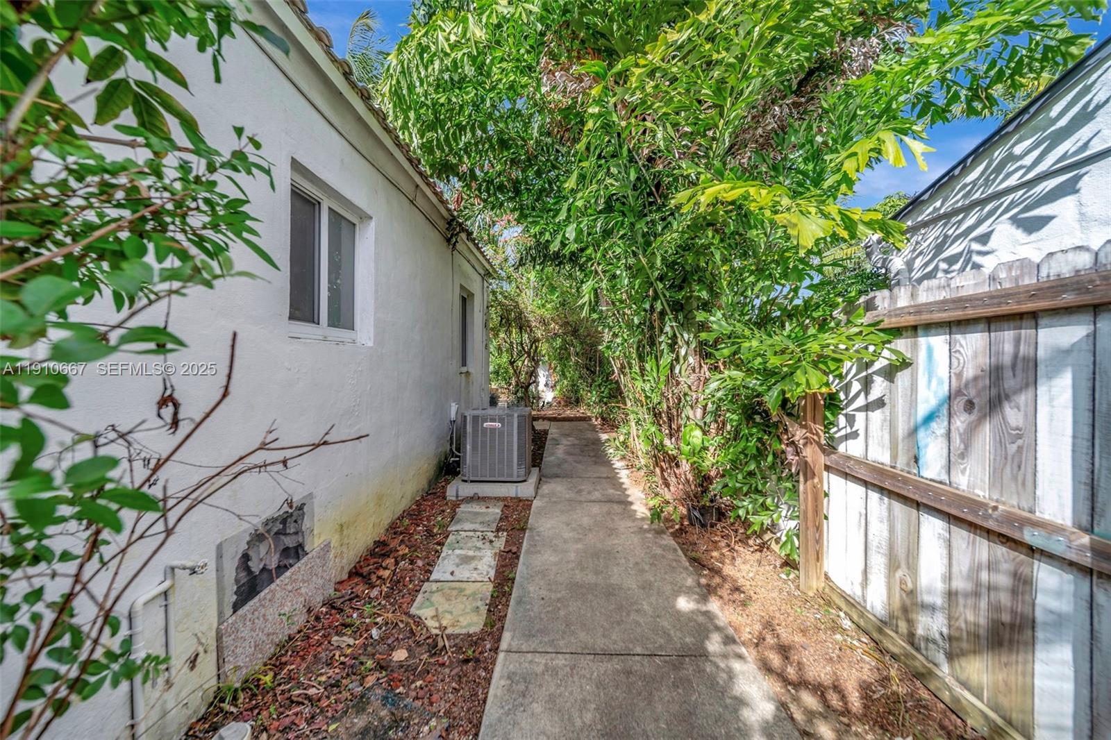 619 Northeast 87th Street Miami, FL 33138 - Photo 34 of 38 a house with trees in front of it