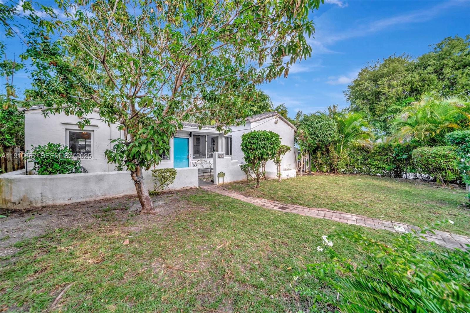 619 Northeast 87th Street Miami, FL 33138 - Photo 37 of 38 a front view of a house with a yard