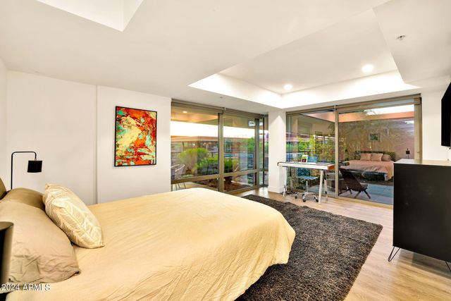 a bathroom with a granite countertop sink a toilet a mirror and vanity